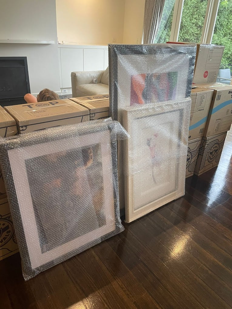 Professionally packed picture frames wrapped in bubble wrap, ready for safe transport — AllCare Removalists Perth fragile item packing service.