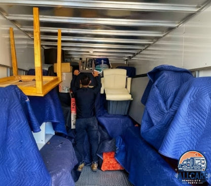 AllCare Removalists Perth team securing and protecting furniture inside a moving truck using professional blankets and packing materials.
