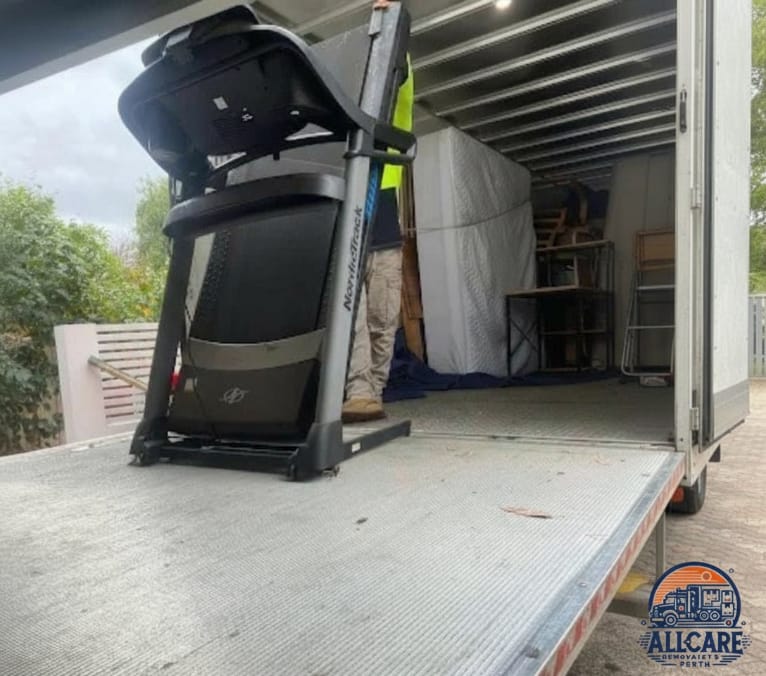 Professional mover from AllCare Removalists Perth loading a treadmill onto a truck — expert gym equipment moving service in Perth.