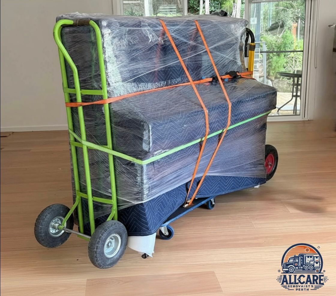 Professional Perth removalist moving a wrapped heavy item on a dolly with full padding and strapping — AllCare Removalists Perth expert handling and protection service.