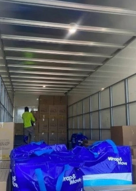 AllCare Removalists Perth professional moving team loading a large truck with blue Wrap & Move bags and boxes expert residential and commercial movers in Perth