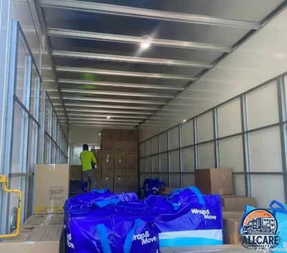 AllCare Removalists Perth team loading a large moving truck with boxes and blue moving bags, demonstrating organised and professional residential moving services.
