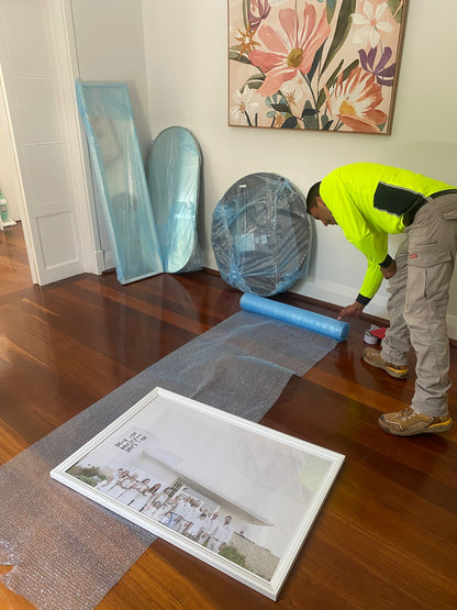 Professional removalist in Perth wrapping mirrors and glass with bubble wrap — AllCare Removalists Perth premium packing service.