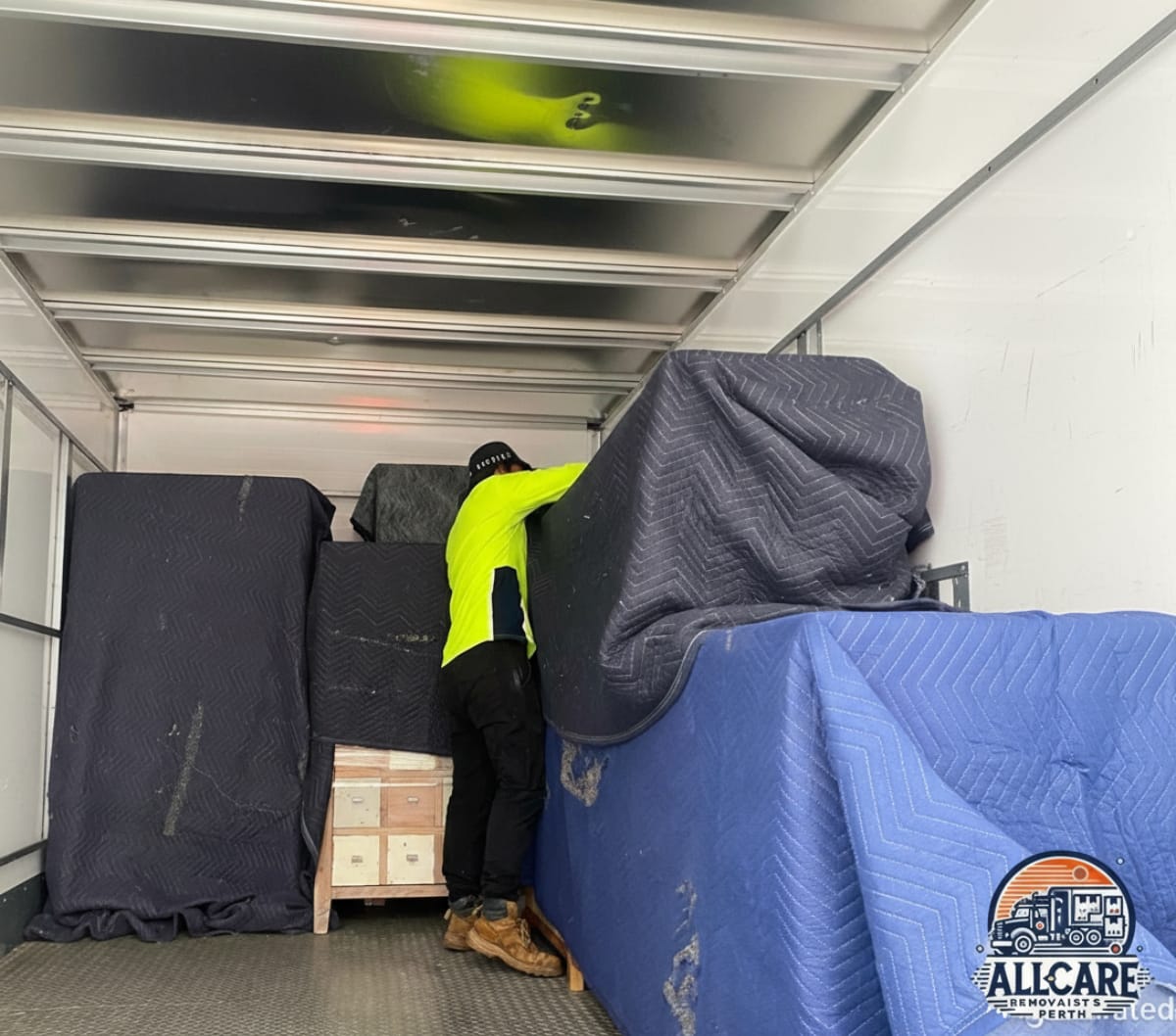 AllCare Removalists Perth team securing and protecting furniture inside a moving truck using heavy-duty blankets — professional furniture protection service in Perth.