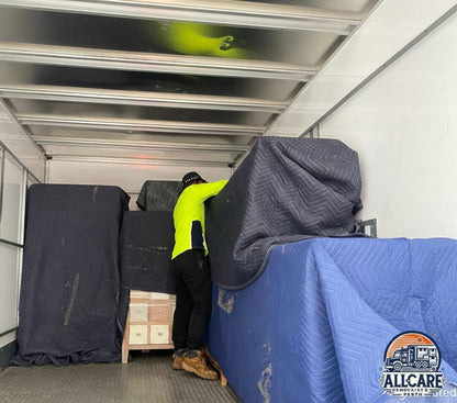AllCare Removalists Perth team securing and protecting furniture inside a moving truck using heavy-duty blankets — professional furniture protection service in Perth.